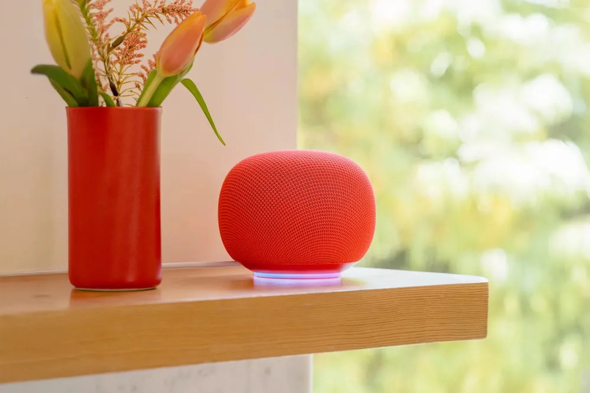 The Google Home Speaker sits on a shelf.